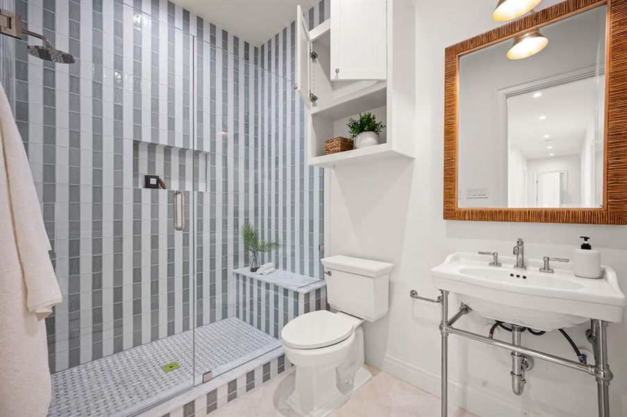 Bathroom with a shower with door and toilet