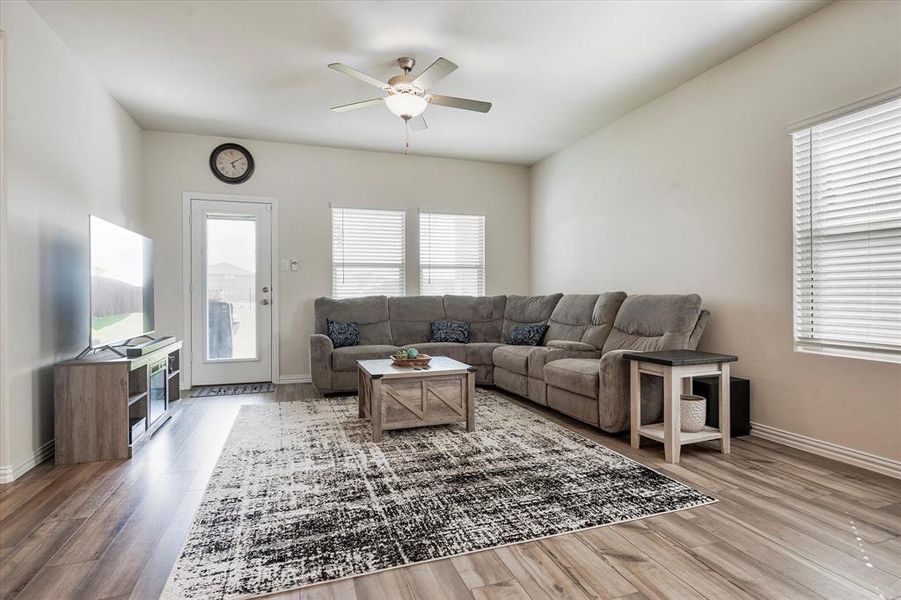 Living room featuring hardwood / wood-style flooring and ceiling fan