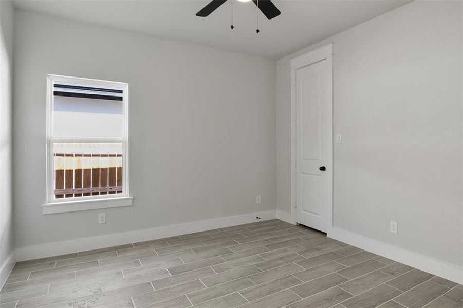 Empty room with light hardwood / wood-style floors and ceiling fan