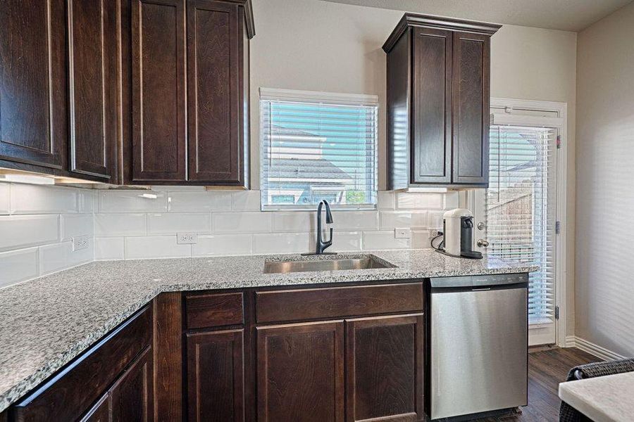 Stained cabinets, granite counters, stainless steel appliances