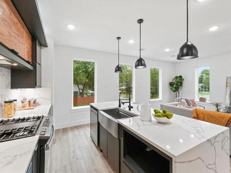 Gas stove, granite countertops, farm sink.