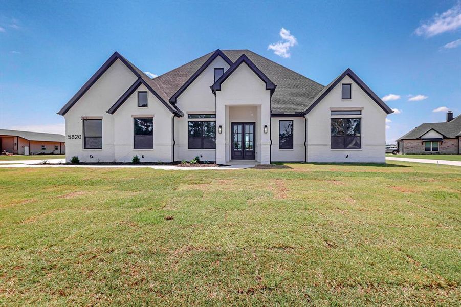 View of front of property with a front yard