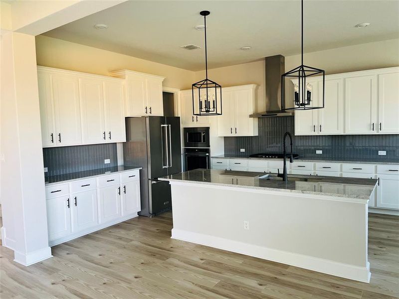 The kitchen comes equipped with upgraded, Kitchen Aid stainless steel appliances, a gorgeous center island, and French-door refrigerator.