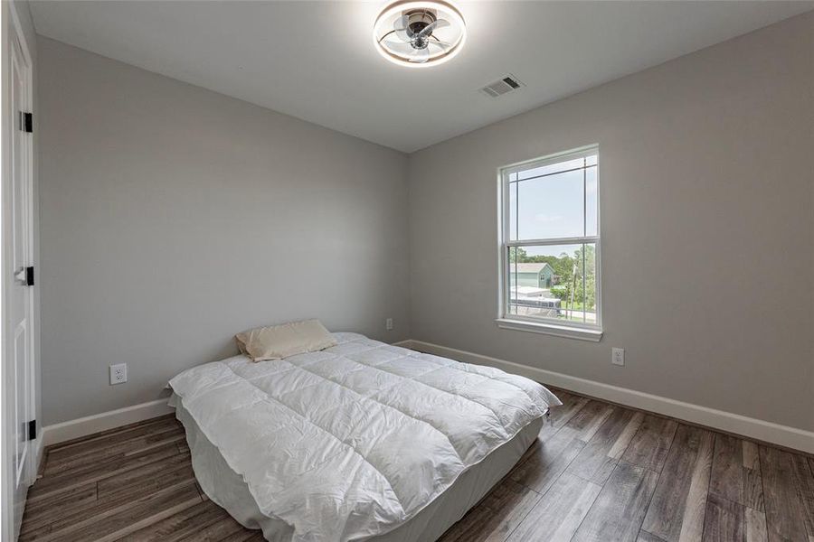 A charming secondary bedroom with generous closet space and large windows