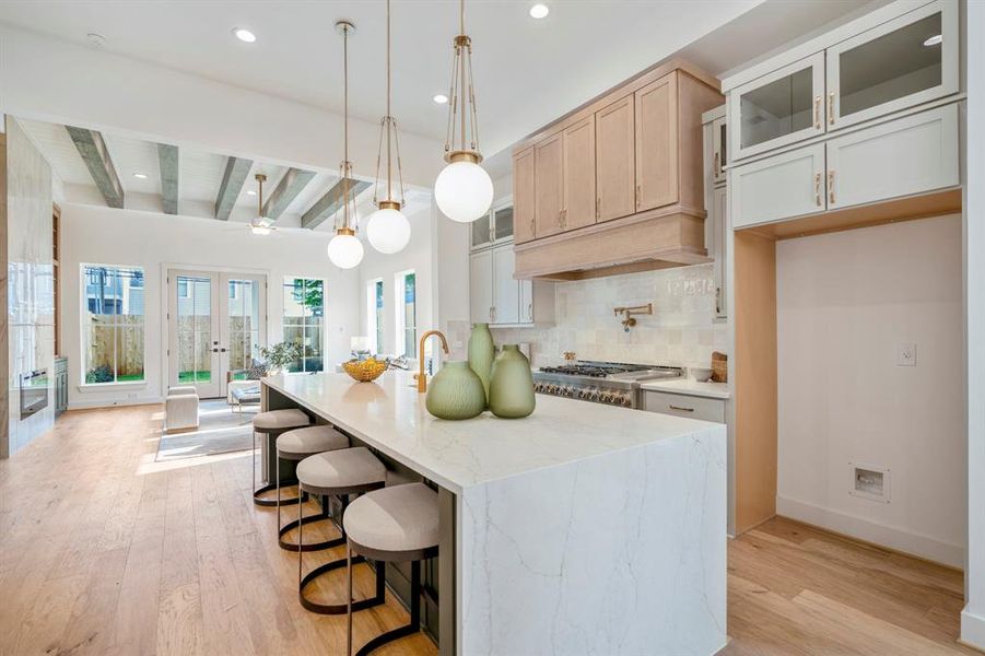 Welcome to your incredible marble waterfall island kitchen! Custom pendant lighting over the island that seats 5 people comfortably.