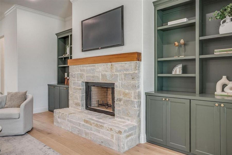 Living room stone fireplace, cedar mantle, and built in shelves and cabinets