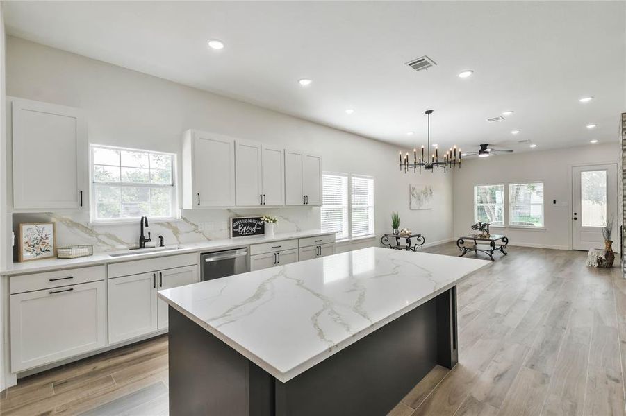 Kitchen island adds a pop of color to this amazing kitchen.