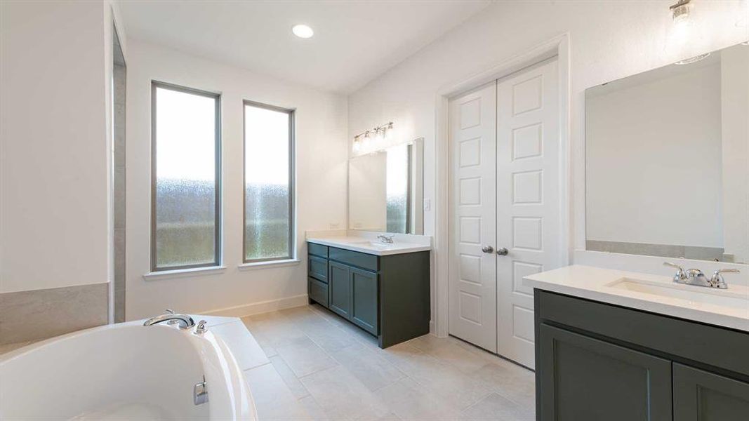 Bathroom featuring a bathtub and vanity