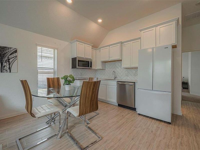 This kitchen boasts ample natural light from the large windows, creating a cheerful and inviting space for breakfast.