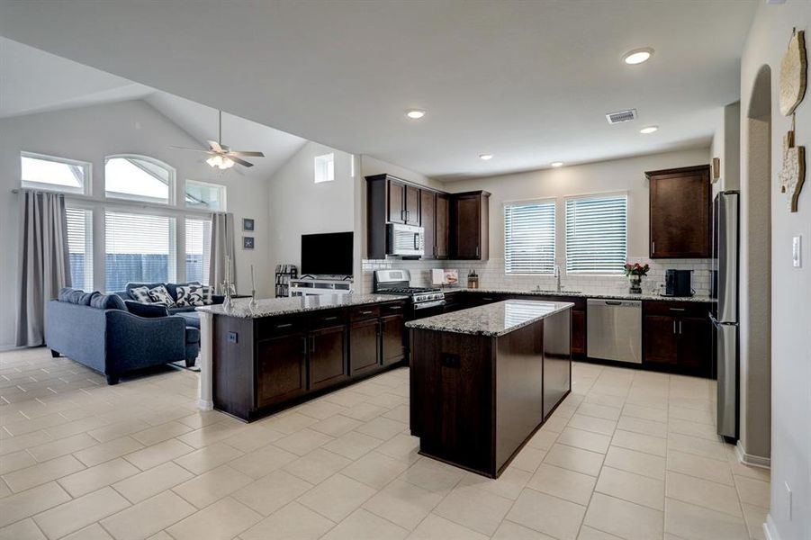Stunning kitchen offers SS appliances, granite counter tops with a huge open bar area.