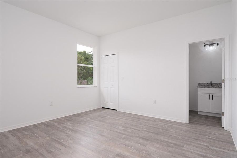 Primary bedroom and bathroom in foreground