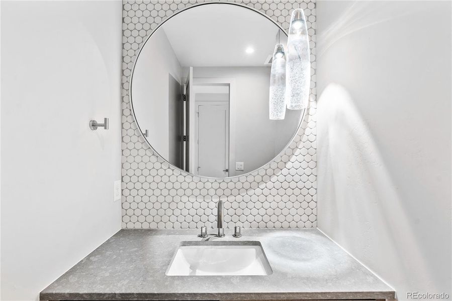 Gorgeous powder bath with floating cabinets.