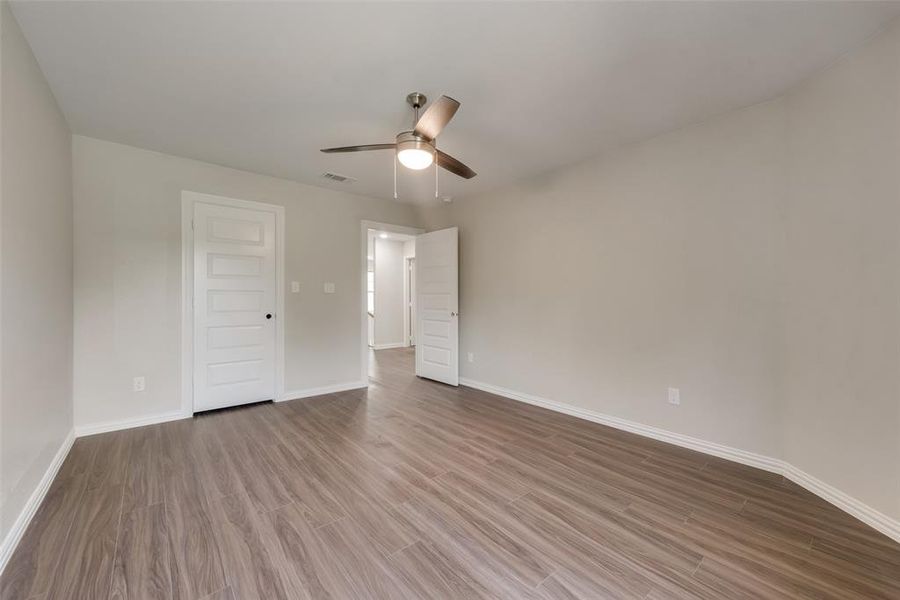 Unfurnished bedroom featuring hardwood / wood-style flooring and ceiling fan