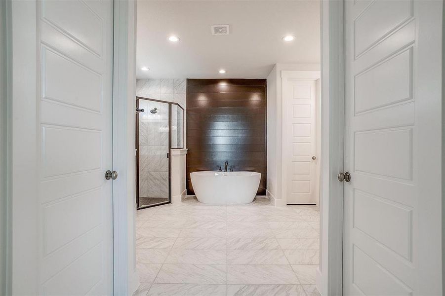 Bathroom featuring independent shower and bath and tile patterned floors