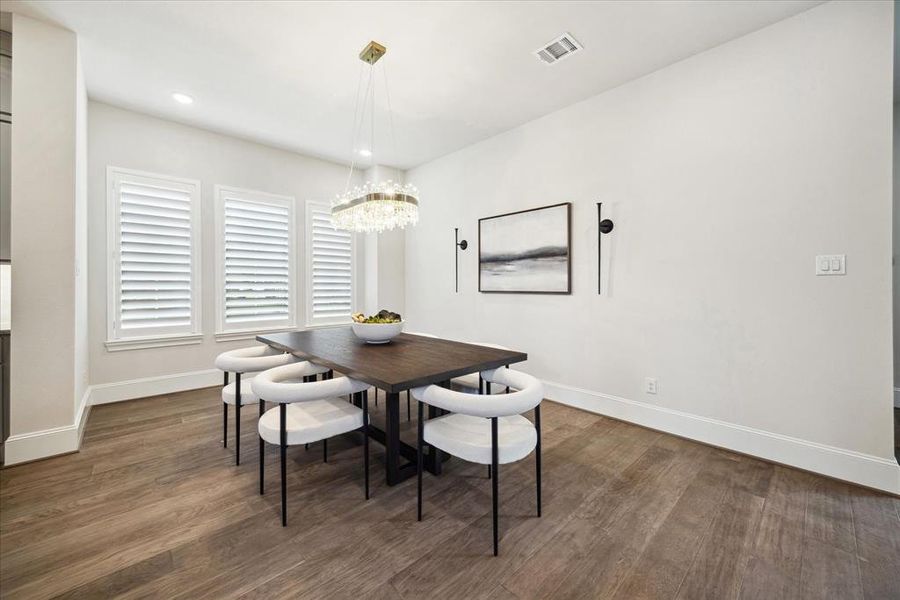 Embrace elegance and sophistication in this inviting dining space, accented by a neutral palette and a newly installed contemporary chandelier. With enough room to accommodate a large dining table, it's ideal for creating lasting memories with family and friends.