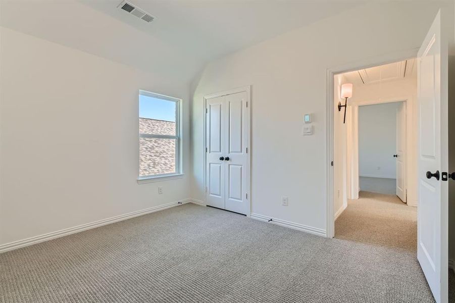 Unfurnished bedroom featuring light colored carpet and a closet