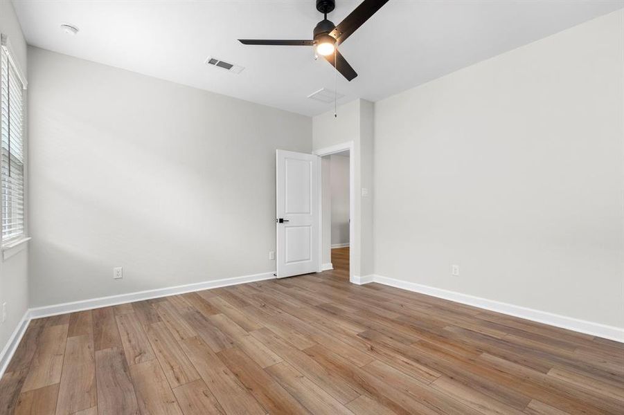 The primary bedroom also has modern vinyl plank flooring.