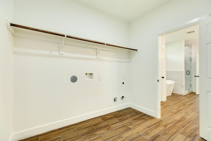 Convenient laundry room located on the other side of the en suite