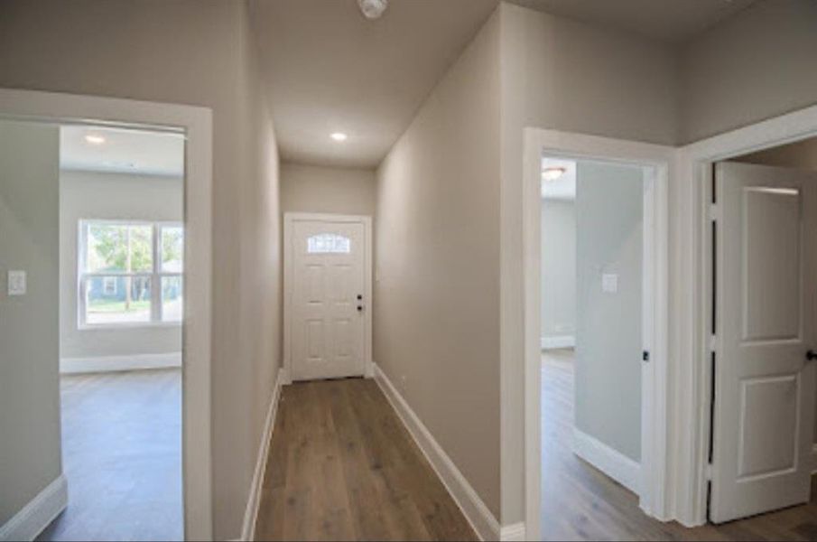 Hallway featuring wood-type flooring