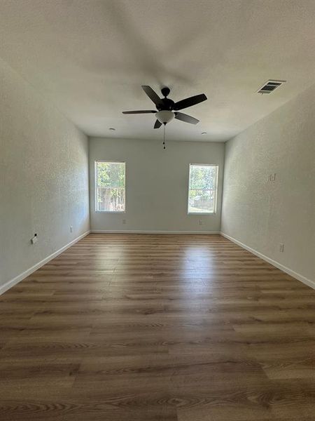 Unfurnished room featuring dark hardwood / wood-style flooring and ceiling fan