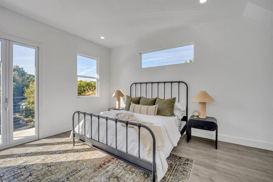 Bedroom with access to exterior and light hardwood / wood-style floors