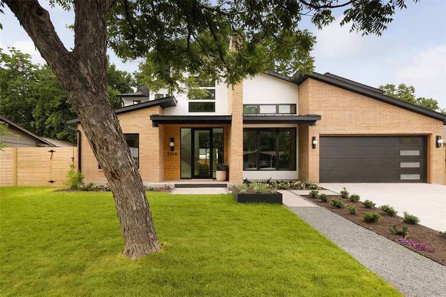 An exterior of modular mid-century brick, real masonry stucco, and stained wood-lap siding create a striking first impression.