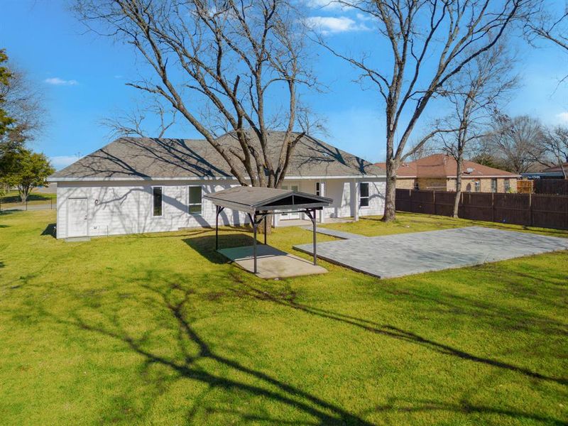 Rear view of house featuring a yard and a patio area