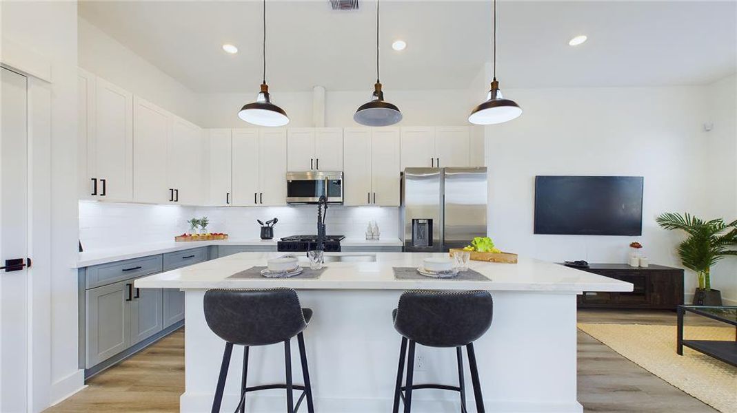 A large kitchen island is perfect for gatherings and food preparation.