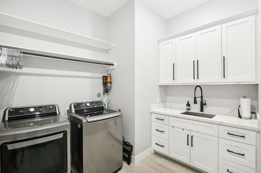 Laundry room with great cabinet space and a sink!!!