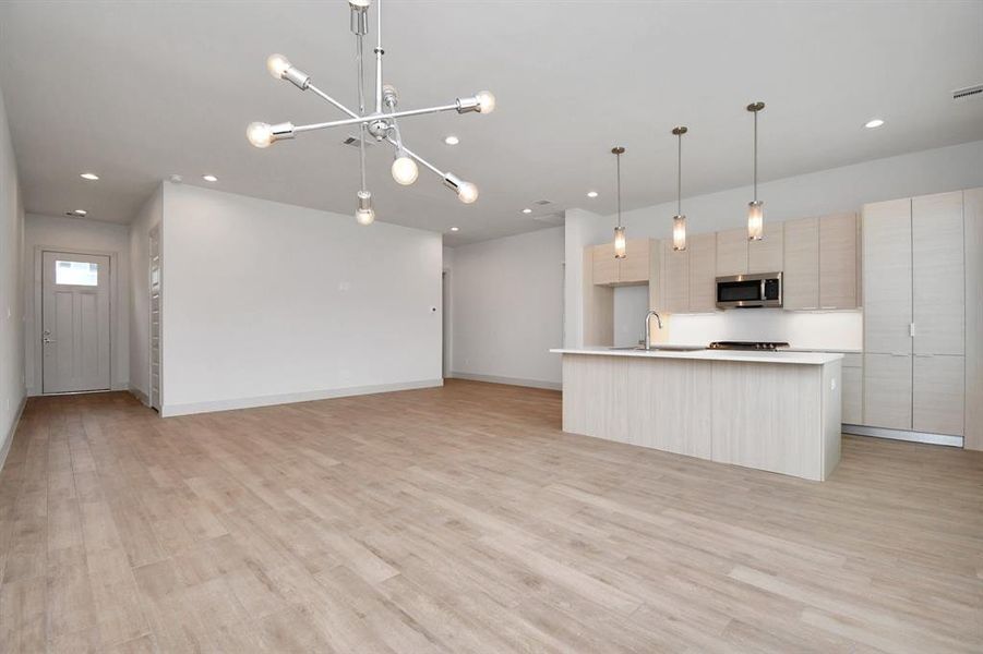 Open floor plan with porcelain tile throughout the first floor