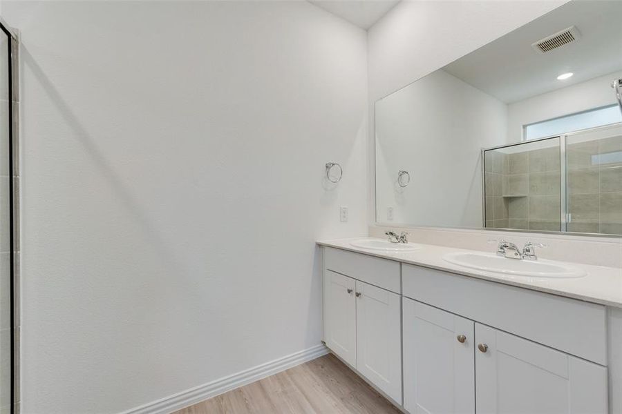 Bathroom featuring double vanity and hardwood / wood-style flooring