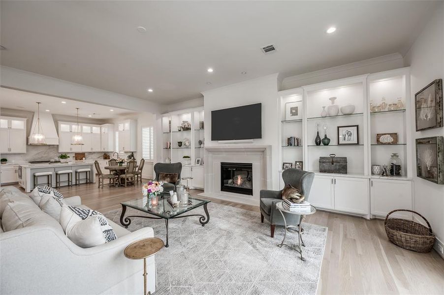 The living room/den features a stone surround fireplace, and easy flow to the marble kitchen and breakfast area.