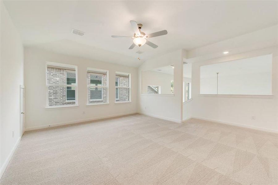 Spare room with light colored carpet and ceiling fan