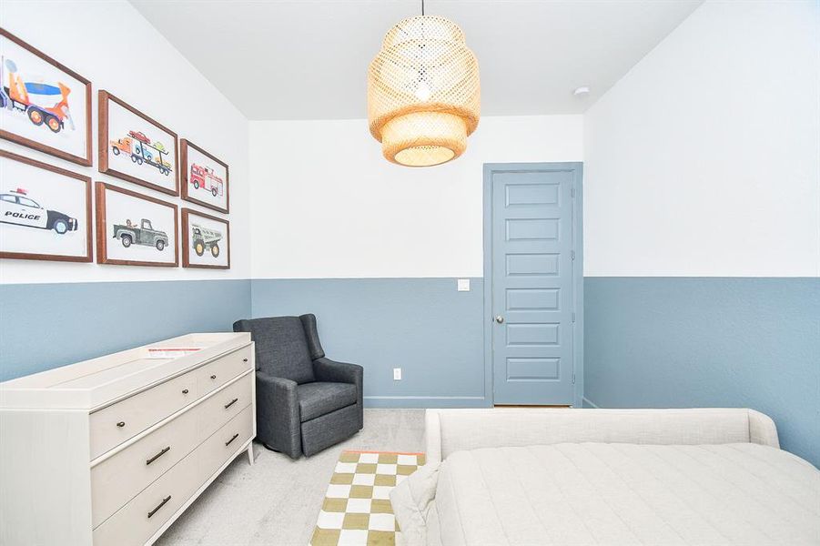 This is a cozy, contemporary bedroom with blue-grey walls and white trim.