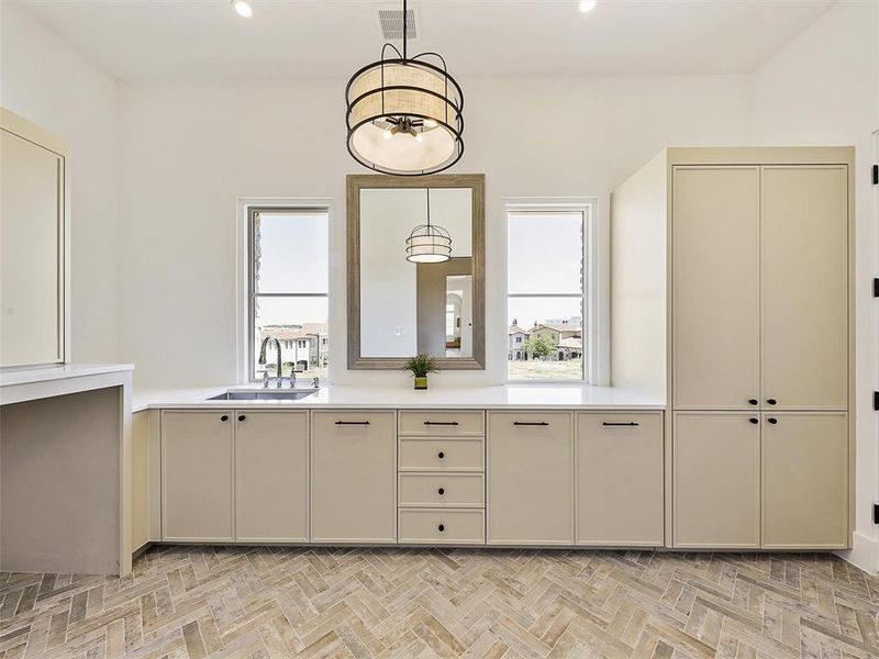 Bathroom featuring parquet floors, vanity, and a wealth of natural light