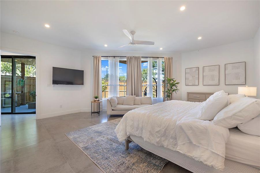 Bedroom with access to outside, multiple windows, and ceiling fan