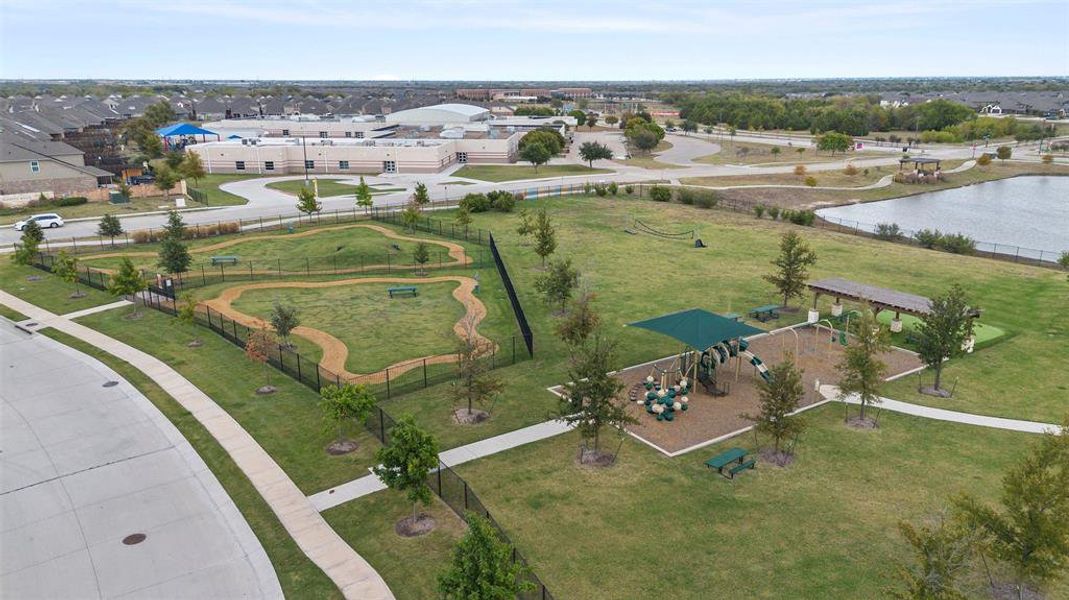 Birds eye view of property with a water view