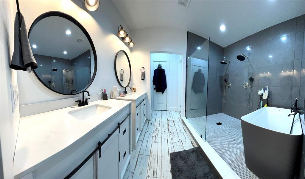 Master Bathroom with oversized vanity, double sink, tile floors, and plus walk in shower