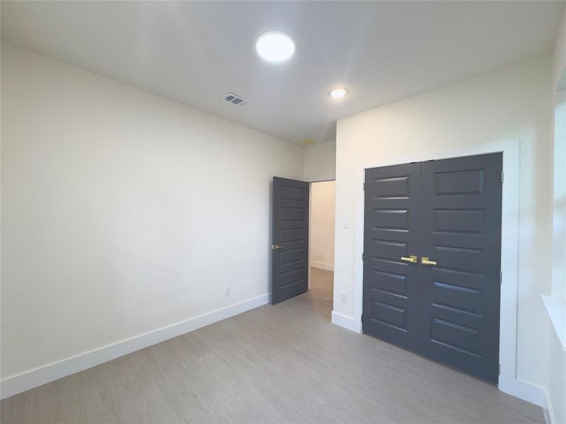 Unfurnished bedroom featuring a closet and light hardwood / wood-style flooring