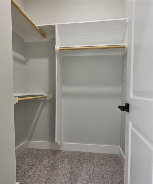 Spacious secondary bedroom closets with plenty of closet rods.