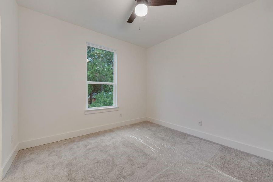 Spare room with carpet floors and ceiling fan