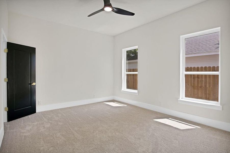 3rd room with carpet flooring and ceiling fan