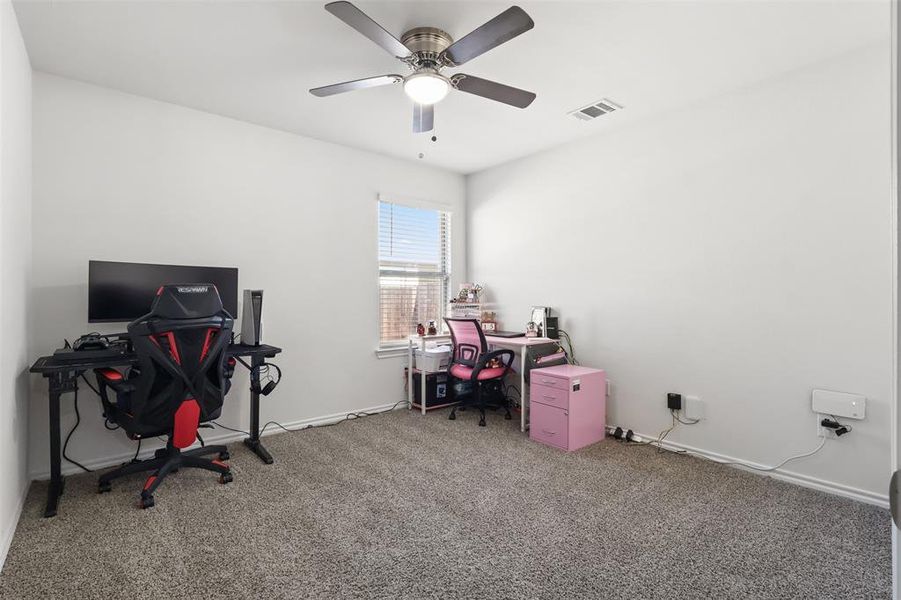 Carpeted office with ceiling fan