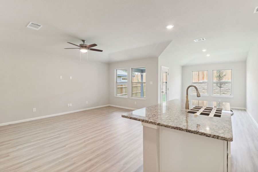 Living room, dining room, and kitchen in the Callaghan floorplan at a Meritage Homes community.