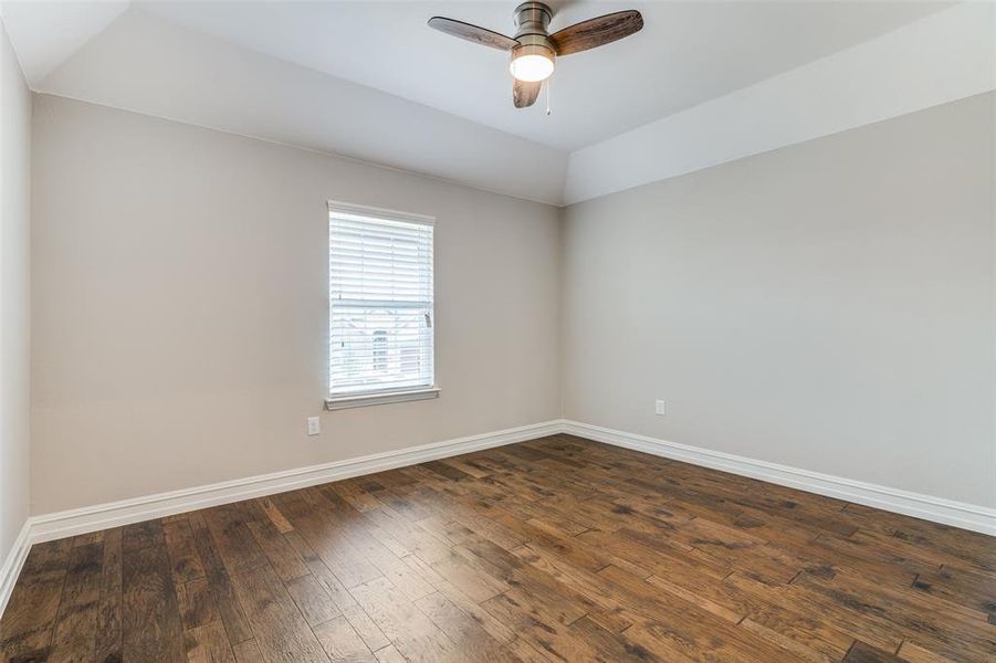 Unfurnished room featuring ceiling fan and dark hardwood / wood-style floors