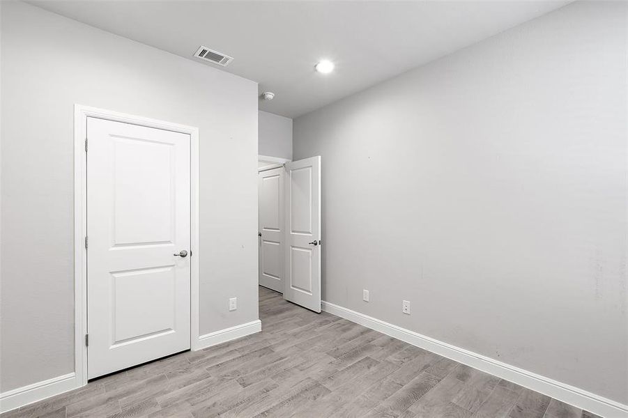 Unfurnished bedroom with light hardwood / wood-style floors