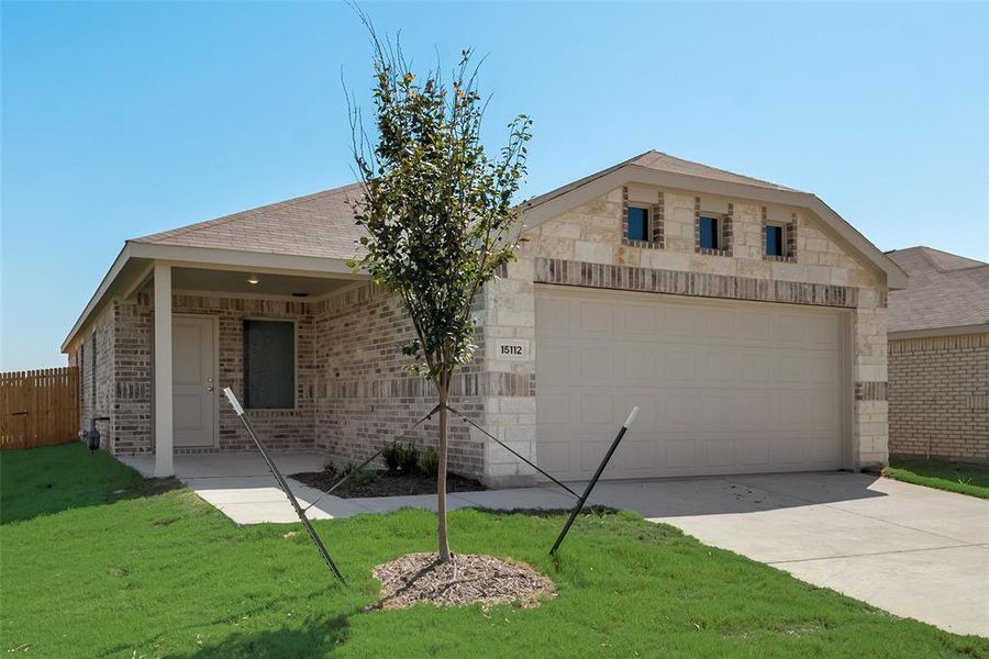 Ranch-style home with a garage and a front lawn