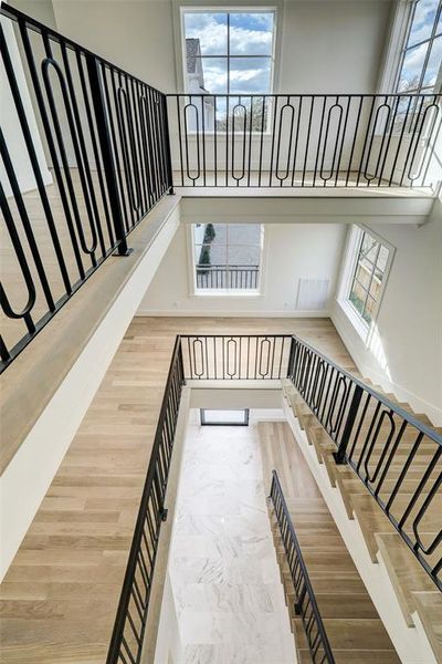 The staircase is a gorgeous architectural masterpiece with the iron railings, wood flooring and large windows! You can see the front door from the 3rd floor.