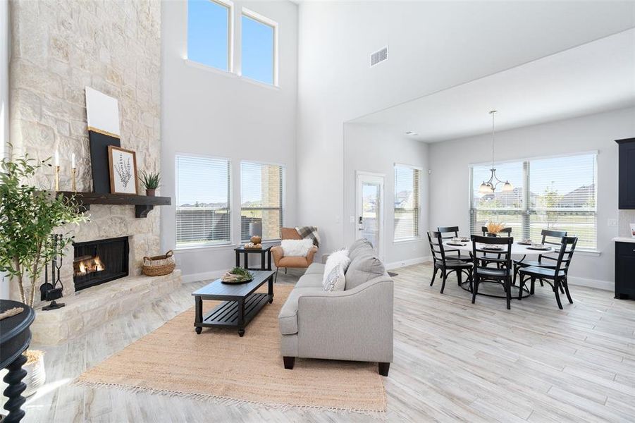 Living room featuring light hardwood / wood-style flooring, plenty of natural light, and a fireplace