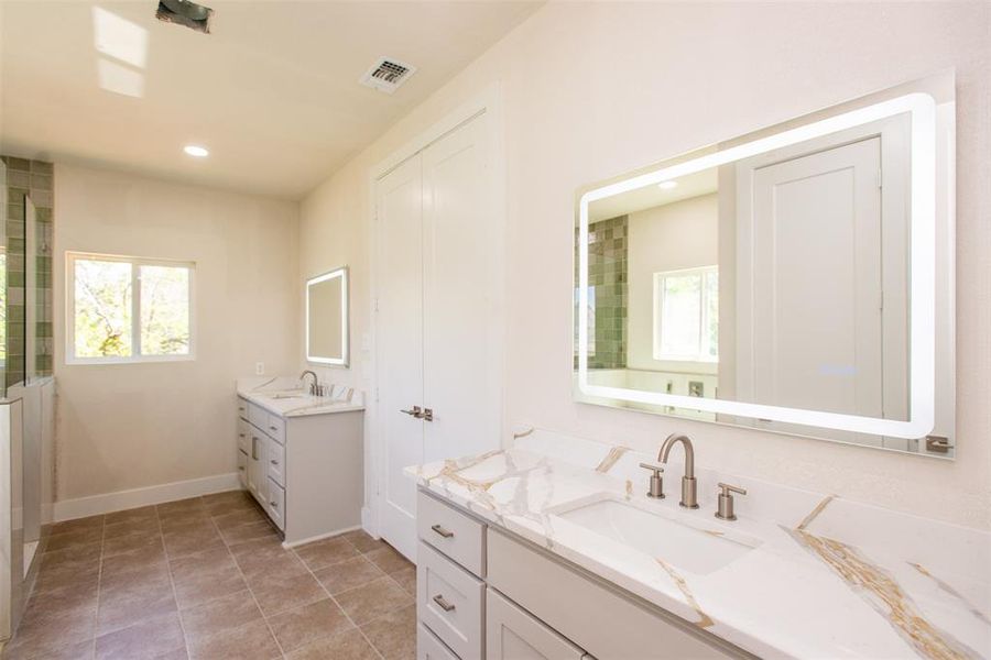 Bathroom featuring tile patterned floors and vanity